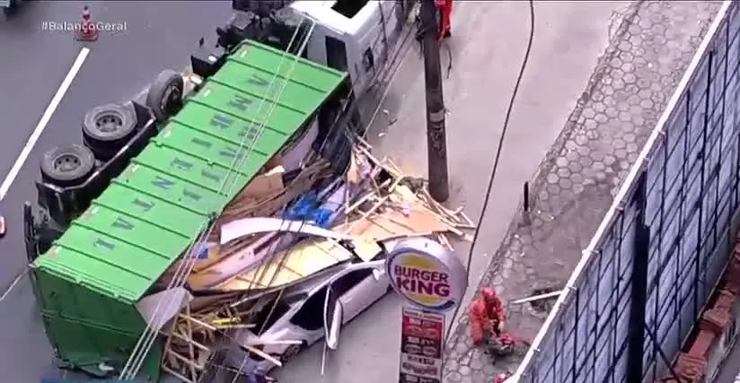 Caminhão de madeira tombou na Rodovia Washington Luiz, em Duque de Caxias, atingindo carro e ônibus. O motorista do ôni…